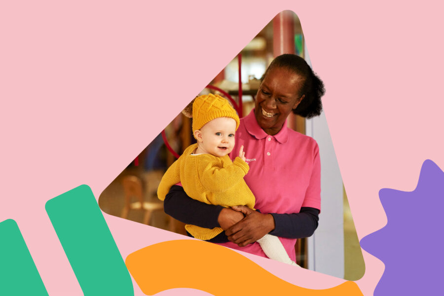 In the shape of a triangle-shaped building block for children, is a photo of a smiling woman holding a baby.