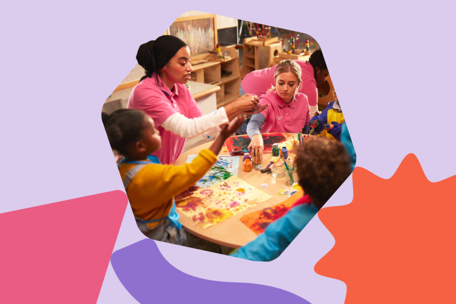 In the shape of a hexagon-shaped building block for children, is a photo of a group of children sitting with two women around a table in a playroom.